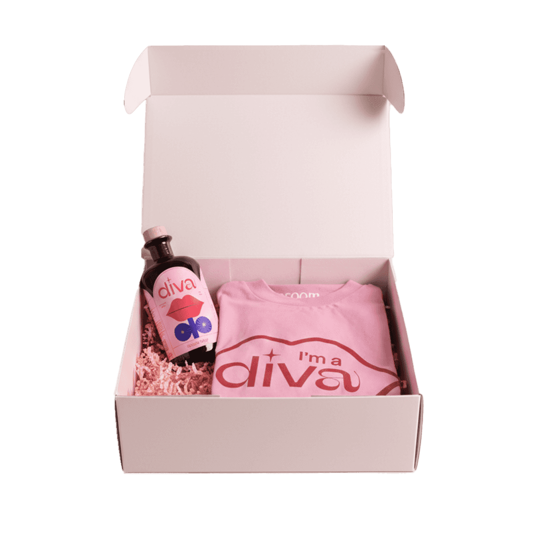 A pink gift box with a t-shirt that says 'I'm a diva' and a bottle labeled 'diva', surrounded by pink shredded paper.