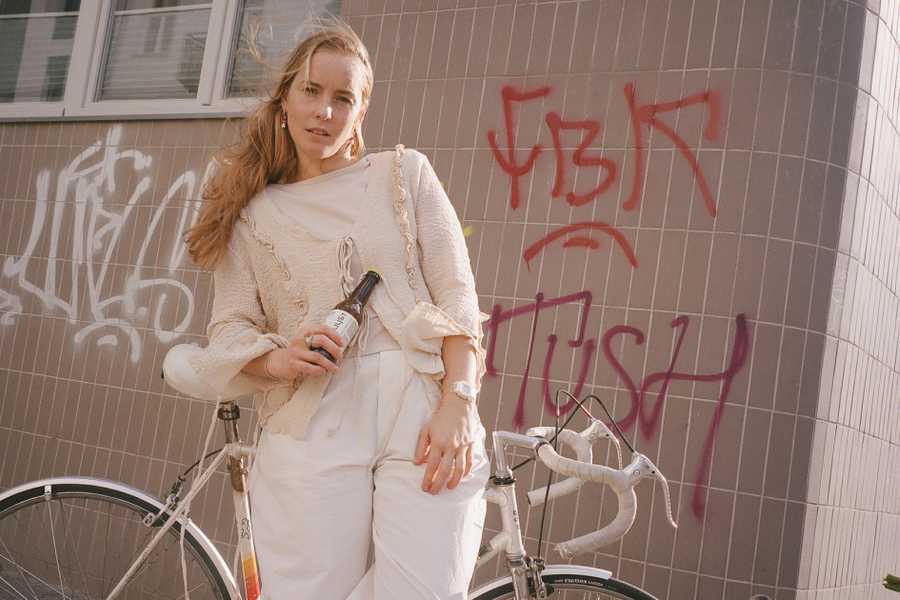 Estera Mrówka - blond girl, with a bike and bottle of shroom relax