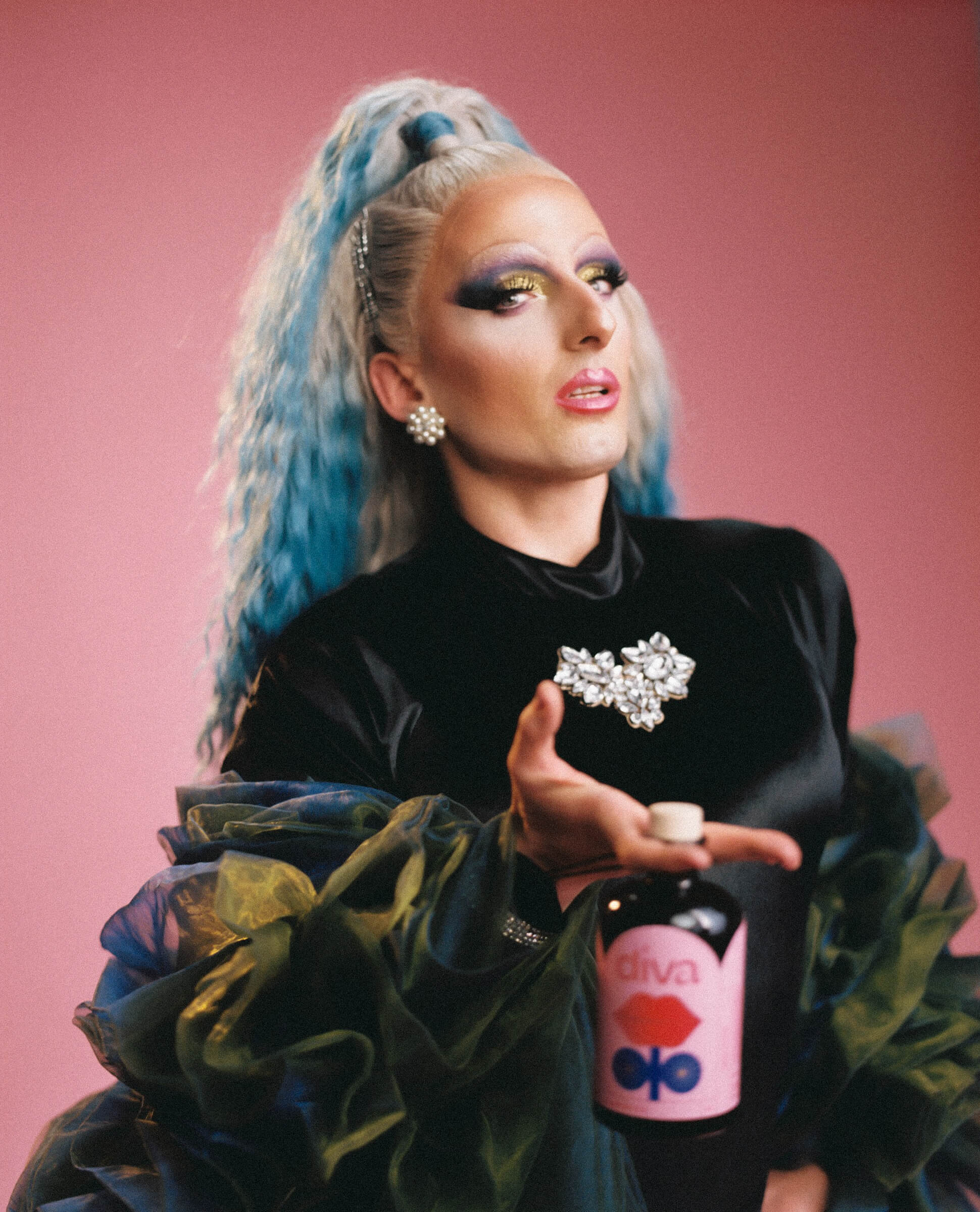 drag queen babsi Bonner with bottle of Diva social elixir by shroom